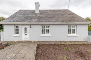 a white house with a driveway in front of it at Explore the west in Loughrea