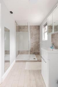 a white bathroom with a shower and a sink at Explore the west in Loughrea +49 photos