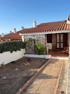 a small house with a porch and a yard at Villetta Rose in Rena Majore +3 photos