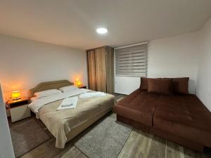 a bedroom with a bed and a couch in it at Gazdinstvo Đurović in Dobra Voda +30 photos