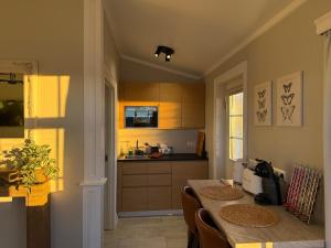 a kitchen with a table with chairs and a counter at Mörk Superior Cottages in Hvammstangi +18 photos