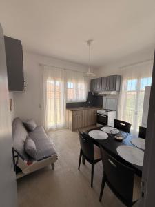 a kitchen with a table and a couch in a room at Methoni Joanna House in Methoni +8 photos