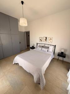 a bedroom with a large bed with a white bedspread at Methoni Joanna House in Methoni