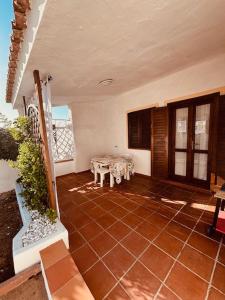 a porch of a house with a table and chairs at Villetta Rose in Rena Majore
