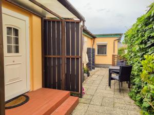 a patio with a door and a table and chairs at Ferienwohnungen Sirius in Zinnowitz +22 photos