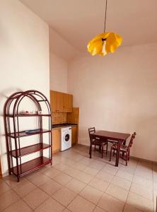 a kitchen with a table and chairs and a dining room at Villetta Rose in Rena Majore