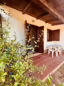 a porch of a house with a table and bench at Villetta Rose in Rena Majore