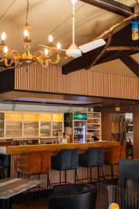 a bar in a restaurant with chairs and tables at A View for Two in Tarchamps
