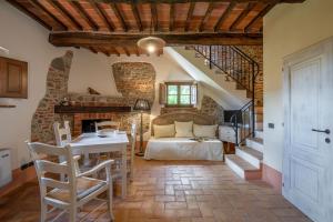 a living room with a bed and a staircase at PODERE BELLARIA 18&2, Emma Villas in Rapolano Terme