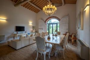 a living room with a table and a couch at PODERE BELLARIA 18&2, Emma Villas in Rapolano Terme