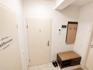 a room with a white door and a stool at Magda's Apartments in Braşov