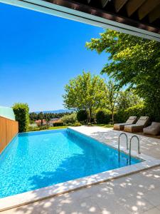 a swimming pool in the backyard of a house at Villa Magnifica - Private Pool, Elevator & Sea View in Paliouri