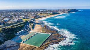 an aerial view of a beach and the ocean at Sunset on the Esplanade in Newcastle