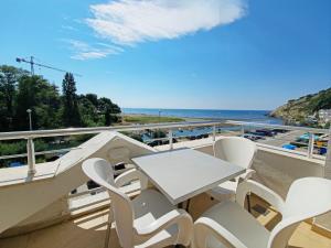a table and chairs on a balcony with a view of the ocean at Apartments Art in Ulcinj