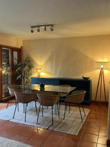 a dining room with a table and chairs at Soltroia Beach House in Carvalhal