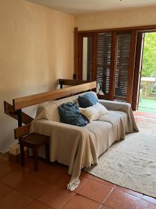 a bed with pillows on it in a room at Soltroia Beach House in Carvalhal