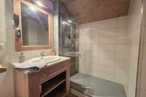 a bathroom with a sink and a shower at Chalet MÖKI accès piscine sauna in Les Déserts