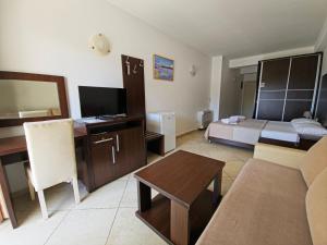 a living room with a couch and a bed at Apartments Art in Ulcinj