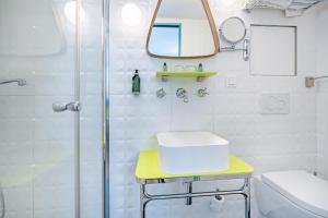 a bathroom with a shower and a sink and a toilet at Hôtel Crayon Rouge - Louvre Palais Royal in Paris