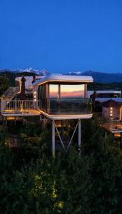 a house on top of a hill with a sunset at Sunny Home Park in Almaty