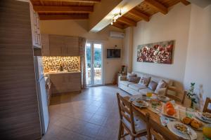 a kitchen and a living room with a table at Chrysianna seaview apartment in Argostoli