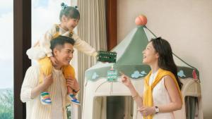a man holding a little girl on top of a play house at Shangri-La Tanjung Aru, Kota Kinabalu in Kota Kinabalu +218 photos