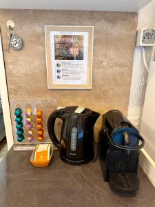 a coffee maker and a tea kettle on a counter at Cabane La Folie Douce in Hotton