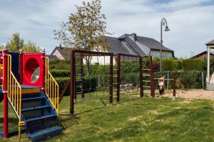 a park with a playground with a slide at A View for Two in Tarchamps