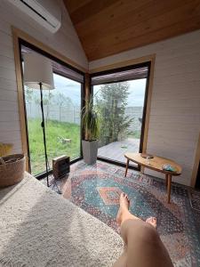 a person laying on a bed in a room with a window at Коворкинг-резорт ololoAkJol in Koshkolʼ +87 photos