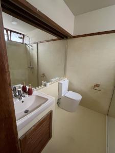 a bathroom with a sink and a toilet at Soltroia Beach House in Carvalhal +25 photos