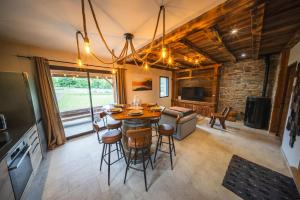 a kitchen and dining room with a table and chairs at Châlet Haut de Gamme Pyrenees in Guchan