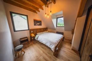 a bedroom with a bed and two windows at Châlet Haut de Gamme Pyrenees in Guchan