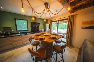 a dining room with a wooden table and chairs at Châlet Haut de Gamme Pyrenees in Guchan +6 photos