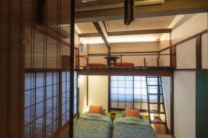 a room with two bunk beds and a window at Tokyo Candle house in Tokyo