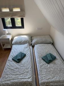 two beds in a small room with at Natka a Ratka in Louka