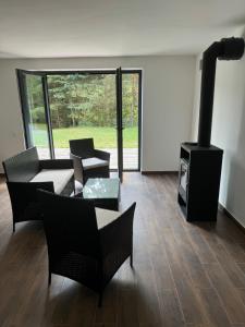 a living room with a fireplace and a stove at Natka a Ratka in Louka