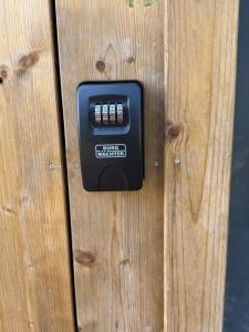 a black electrical outlet on a wooden fence at Natka a Ratka in Louka