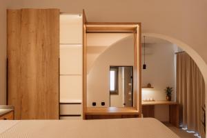 a bedroom with a mirror and a bed at Ios Panoramic Sea view stylish suite with pool in Tzamaria +11 photos