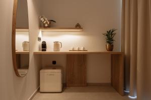 a bathroom with a toilet in a room with a shelf at Ios Panoramic Sea view stylish suite with pool in Tzamaria