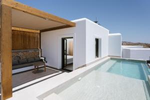 a villa with a swimming pool and a house at Ios Panoramic Sea view stylish suite with pool in Tzamaria