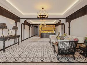 a living room with a couch and a chandelier at La Resident Indochina Hotel in Vientiane