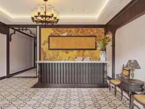 a lobby of a hotel with a tub and a chandelier at La Resident Indochina Hotel in Vientiane