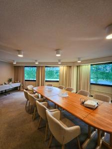 a conference room with a large wooden table and chairs at Hotel Ivalo in Ivalo +35 photos