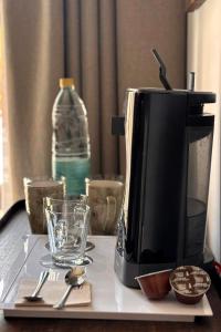 a microwave sitting on a table next to a water bottle at Soller Plaza in Sóller