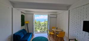 a living room with a blue couch and a table and a window at Krkulj Apartments in Ohrid