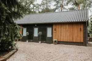 a small house with a gravel yard in front of it at ForRest Suites in Ermelo