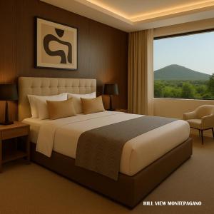 a bedroom with a large bed and a large window at GRAND HOTEL OLIVIER PRINCe in Roseto degli Abruzzi +5 photos