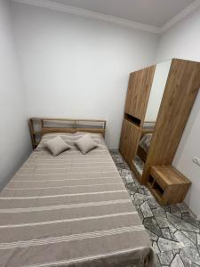 a bedroom with a bed and a mirror at Гостевой дом in Oganavan