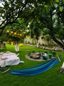 a blue hammock on the grass in a park at Гостевой дом in Oganavan