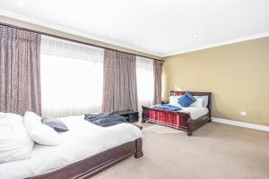 a bedroom with two beds and a window at Bryanston stays in Johannesburg